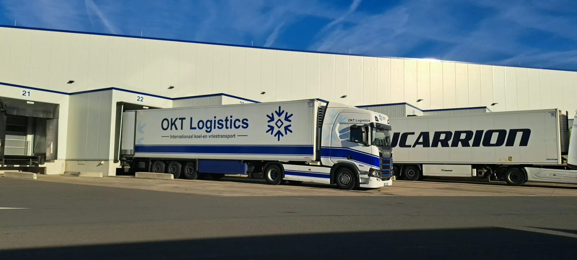 OKT Logistics refrigerated truck at a loading dock in Wuppertal, Germany